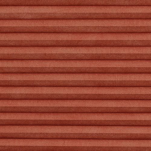 Pleated cellular blind, tightly closed, terracotta textured fabric with horizontal ribs; blocking view and softly diffusing light, close-up framing fills the frame with warm, even illumination.