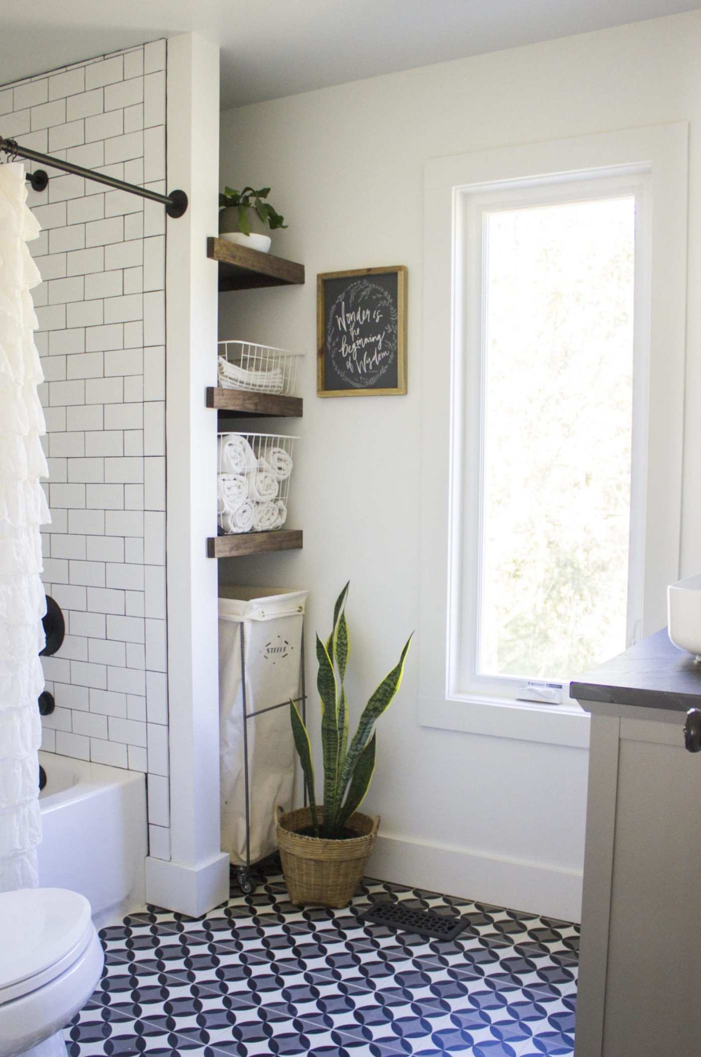 a bathroom with a black and white tile floor.