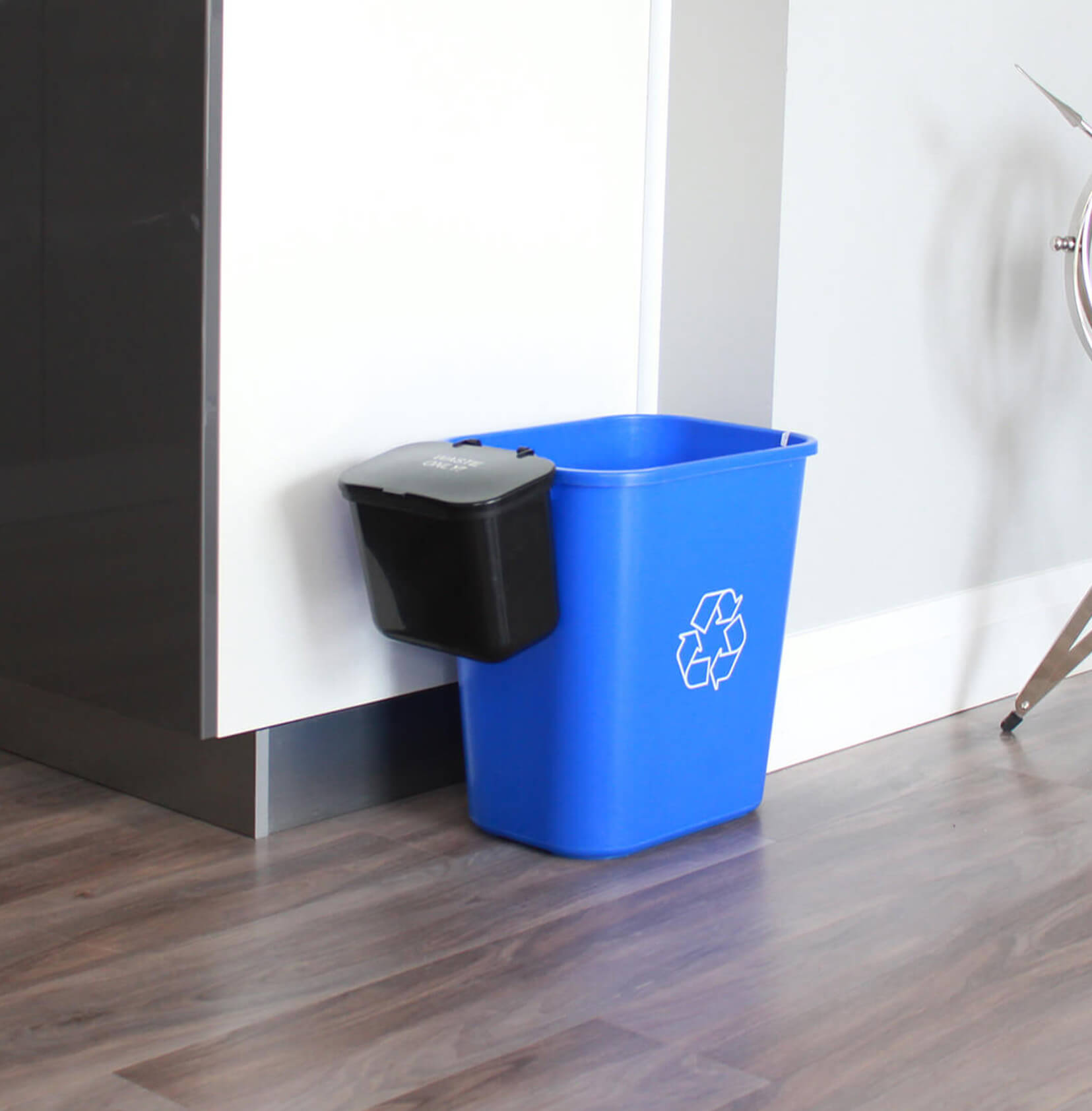 deskside recycling container with a hanging waste basket on the side sitting in a corporate office meeting room