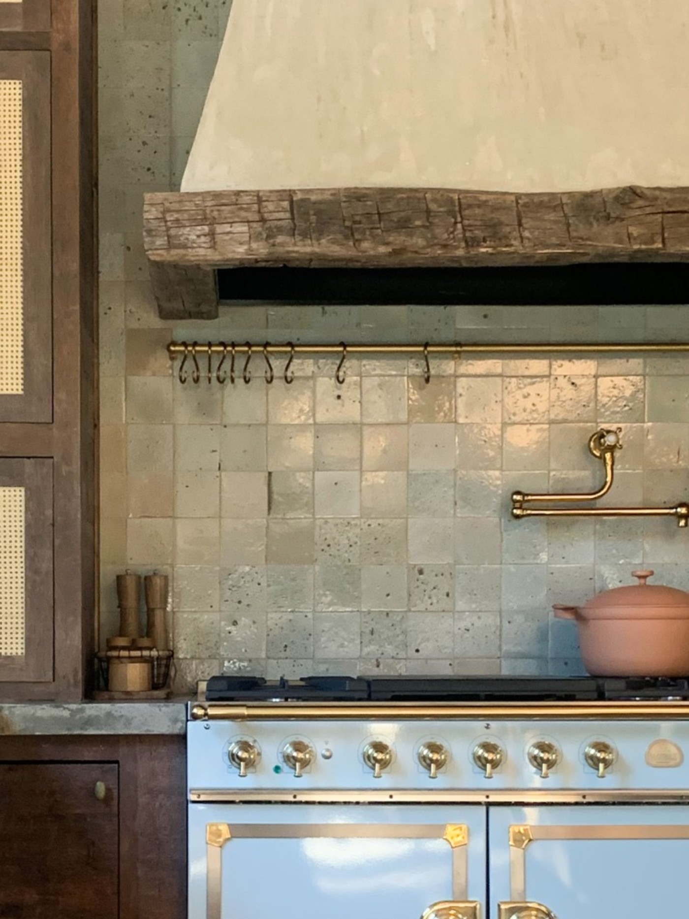 a kitchen with a blue stove and wooden cabinets.