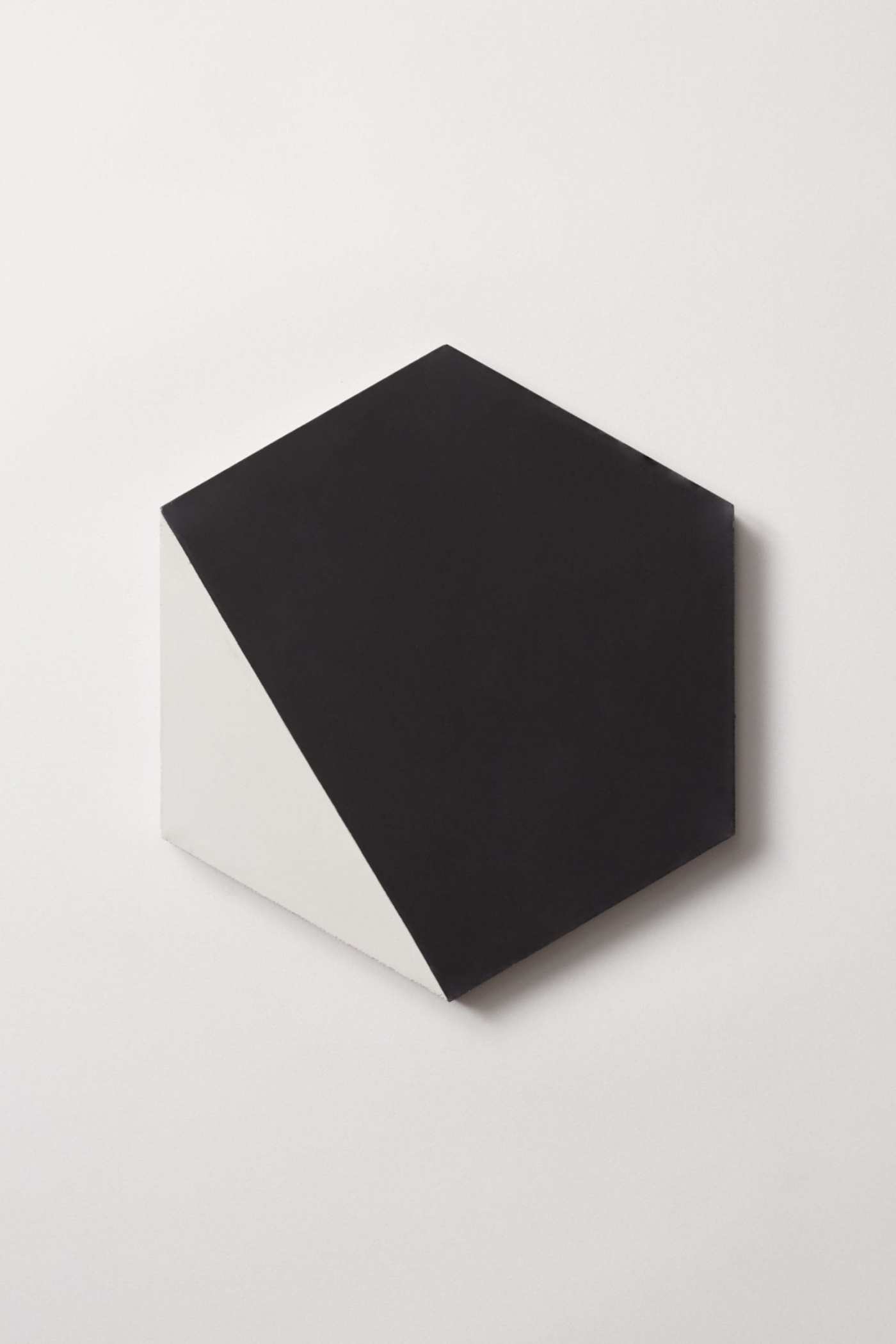 a black and white hexagonal tile on a white surface.