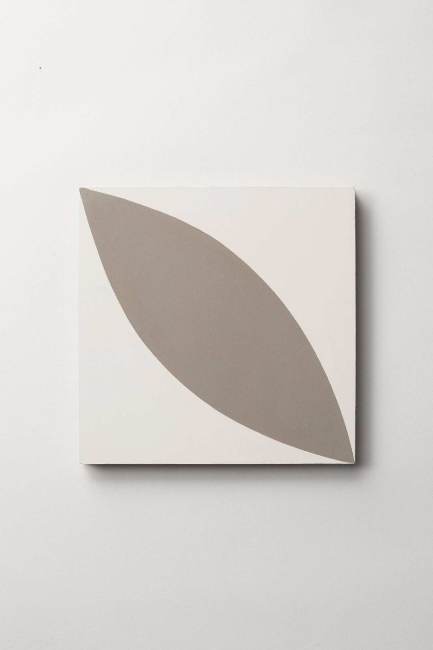 a white and gray tile on a wall.