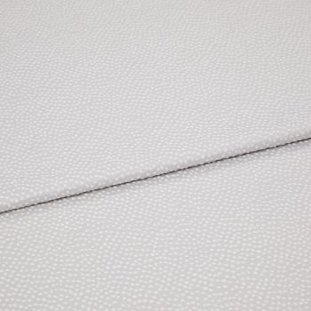 Light-gray fabric with small white dotted texture, folded diagonally with an overlapping edge; close-up view on a plain surface under soft, even lighting.