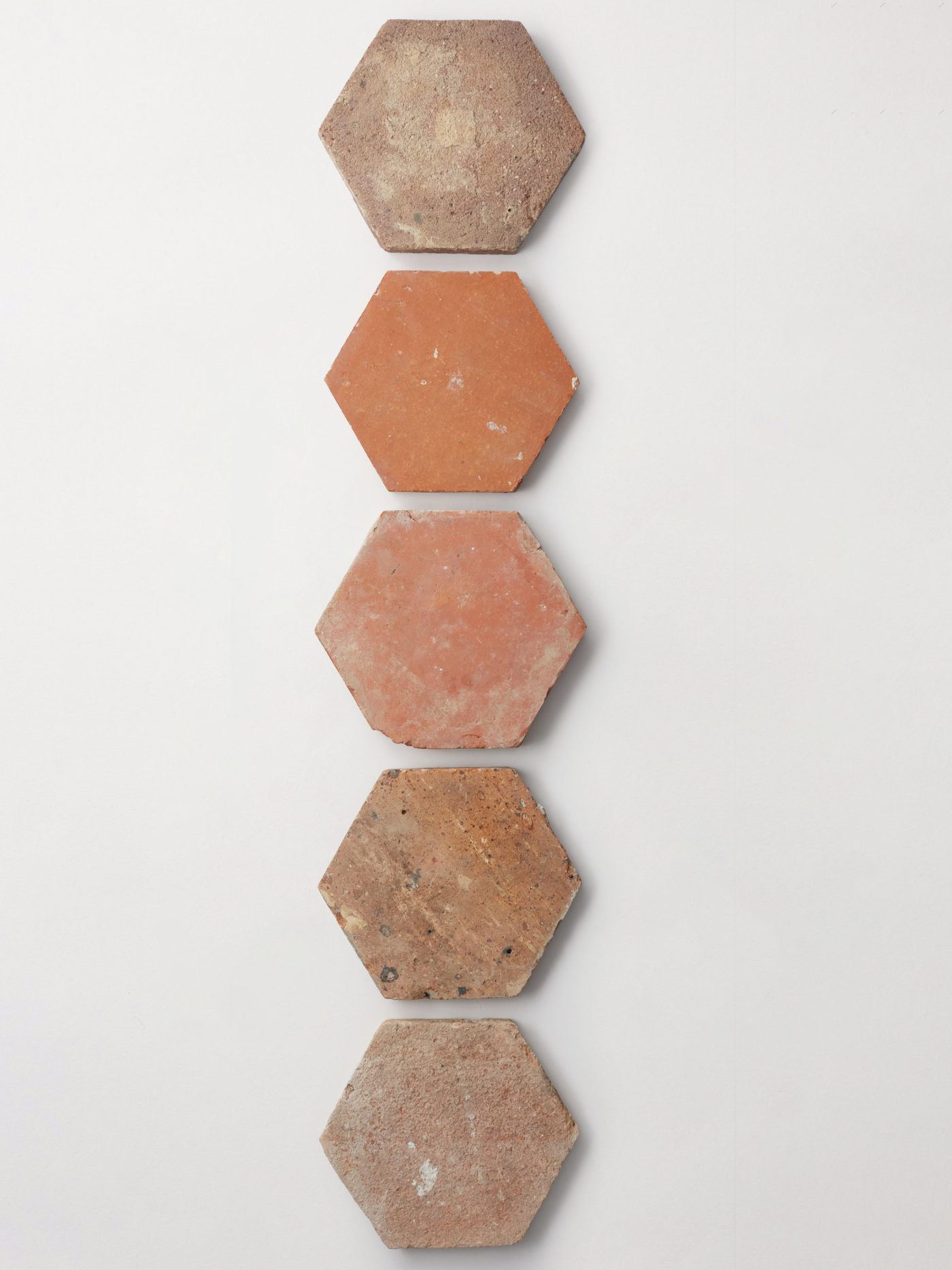 a row of hexagonal tiles on a white wall.