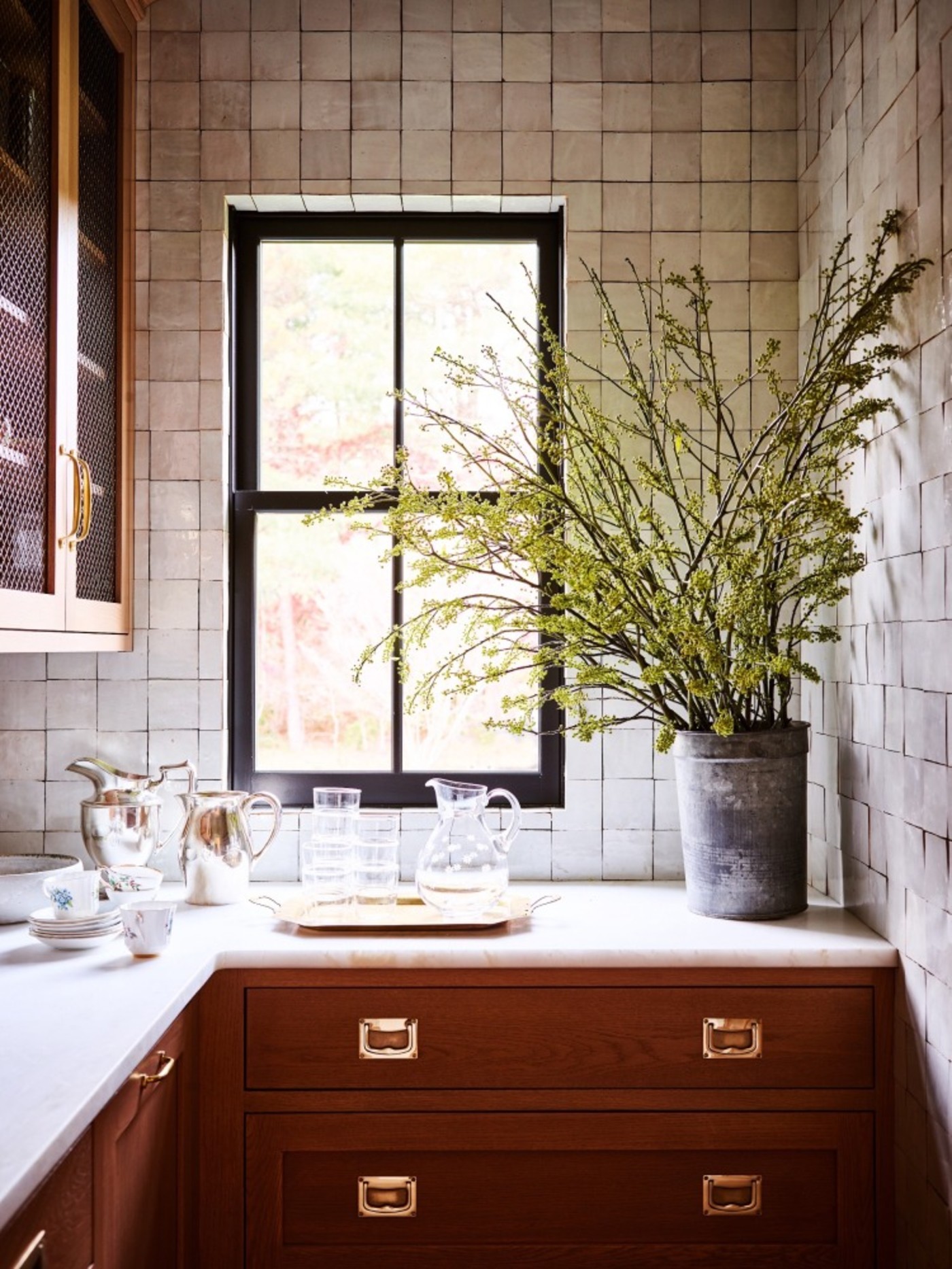 a window in a kitchen with a plant in it.