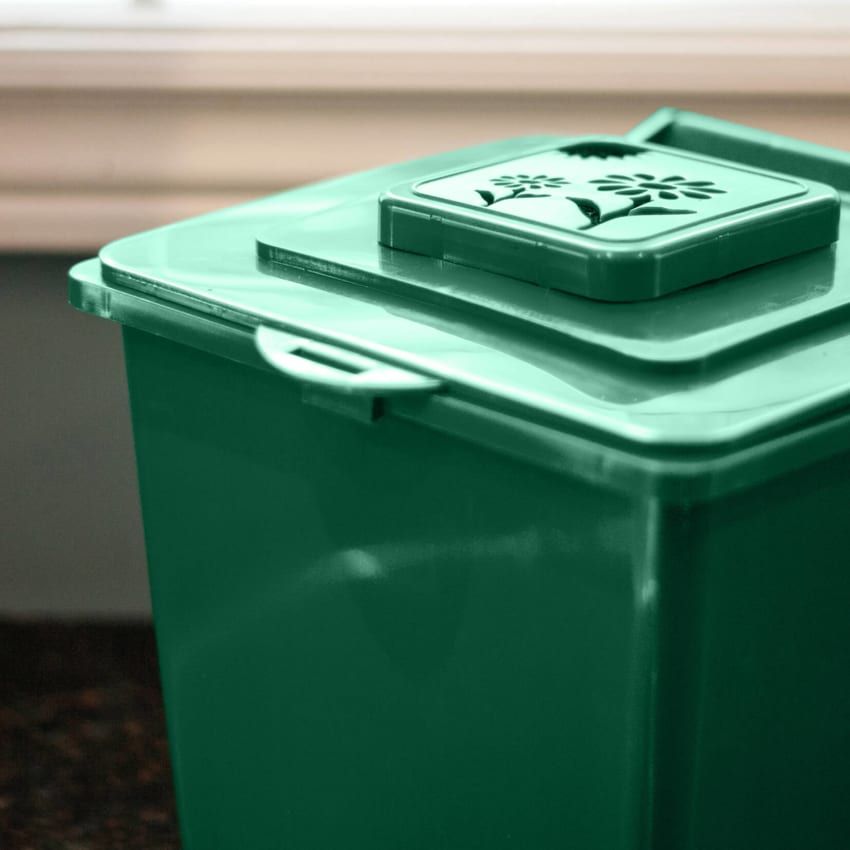 closeup images showing the vented lid on a green plastic organics collection bin