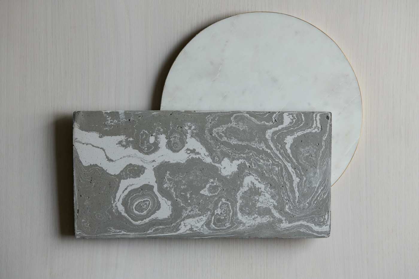 a white and grey marble plate on a white surface.