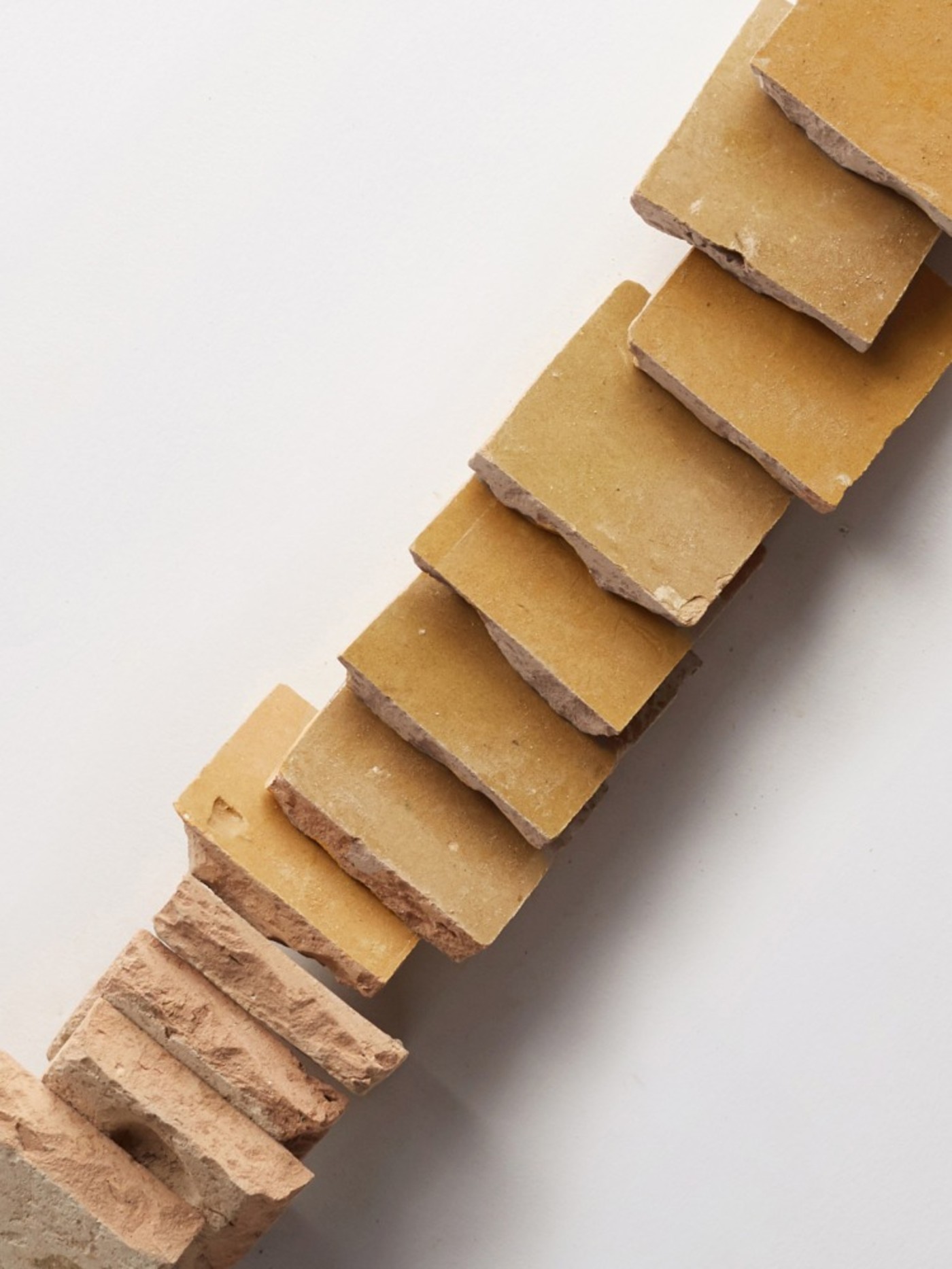 a stack of yellow tiles on a white background.