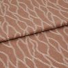 Folded terracotta-brown fabric with raised white embroidered undulating chain pattern, folded over itself with a horizontal overlap, close-up studio view emphasizing woven texture and soft, even lighting.