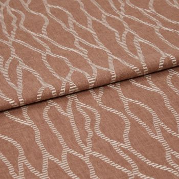 Folded terracotta-brown fabric with raised white embroidered undulating chain pattern, folded over itself with a horizontal overlap, close-up studio view emphasizing woven texture and soft, even lighting.
