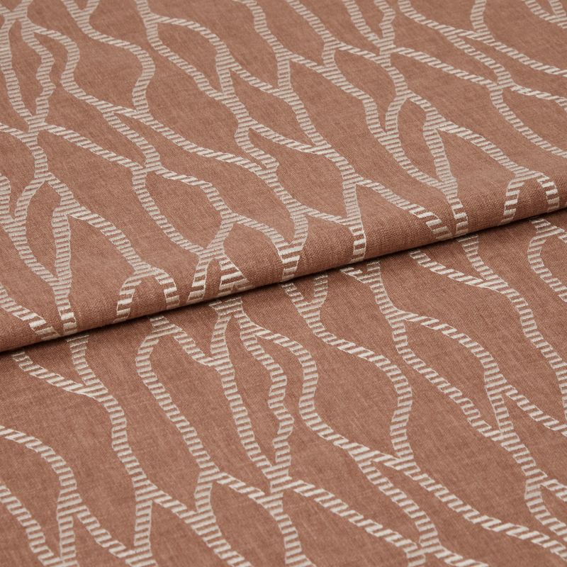 Folded terracotta-brown fabric with raised white embroidered undulating chain pattern, folded over itself with a horizontal overlap, close-up studio view emphasizing woven texture and soft, even lighting.