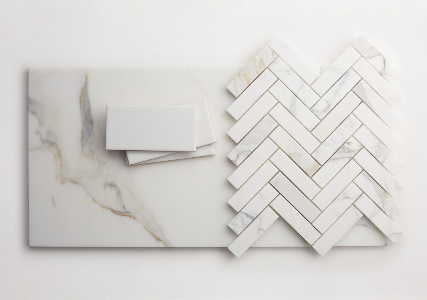 various shapes of white marble tile on a white surface.