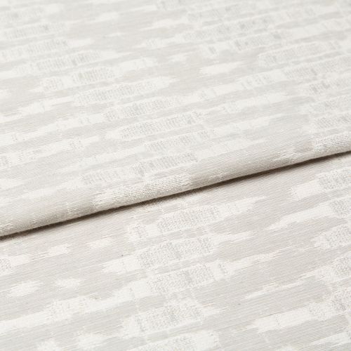 Off-white woven curtain fabric folded horizontally, showing a subtle geometric jacquard pattern; soft, diffused light highlights the texture in a neutral, close-up interior view.
