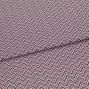 Folded fabric featuring tight purple-and-white chevron stripes, folded to form a shallow diagonal ridge; close-up view of a flat textile sample with even, neutral lighting.