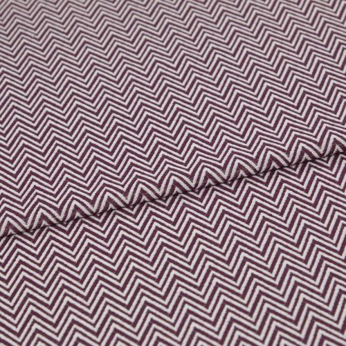 Folded fabric featuring tight purple-and-white chevron stripes, folded to form a shallow diagonal ridge; close-up view of a flat textile sample with even, neutral lighting.