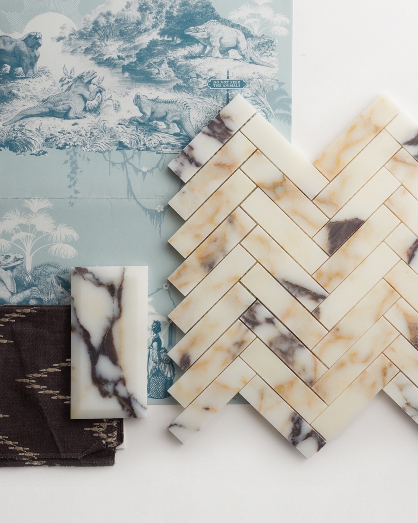 marble tile in a chevron pattern with other tiles on a white surface.