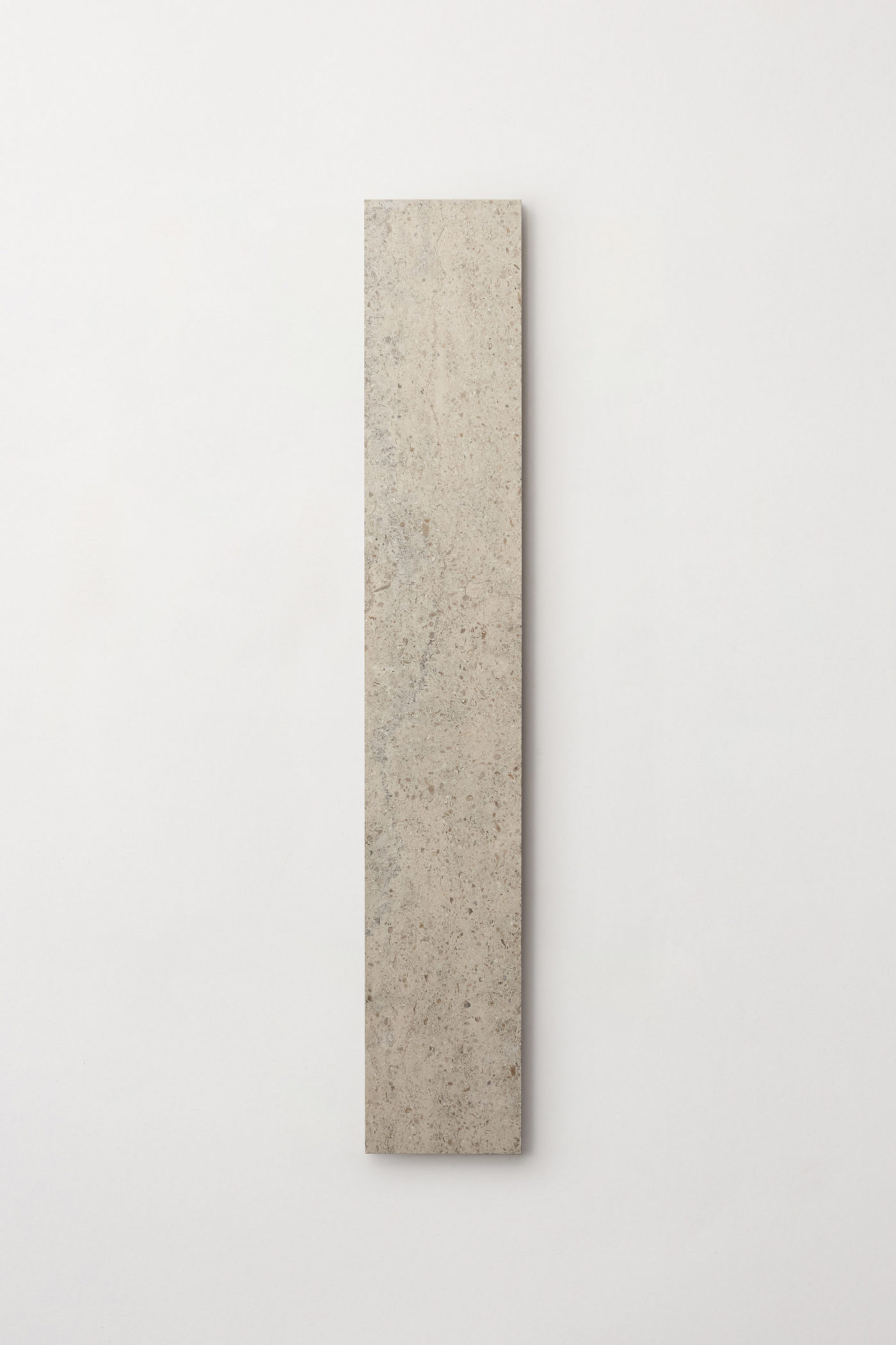 a long rectangular grey limestone tile on a white background.