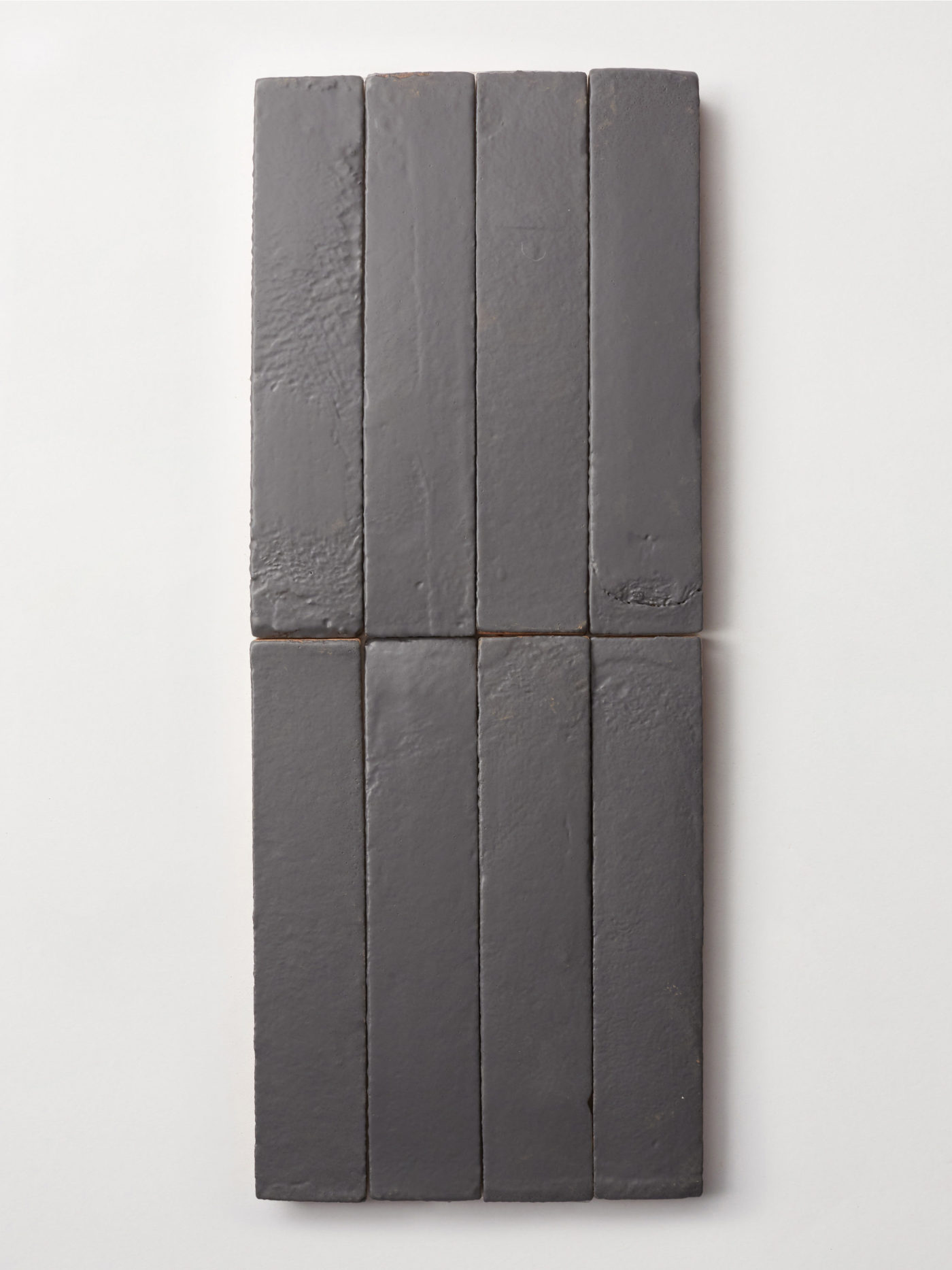 a group of grey rectangle tiles on a white surface.