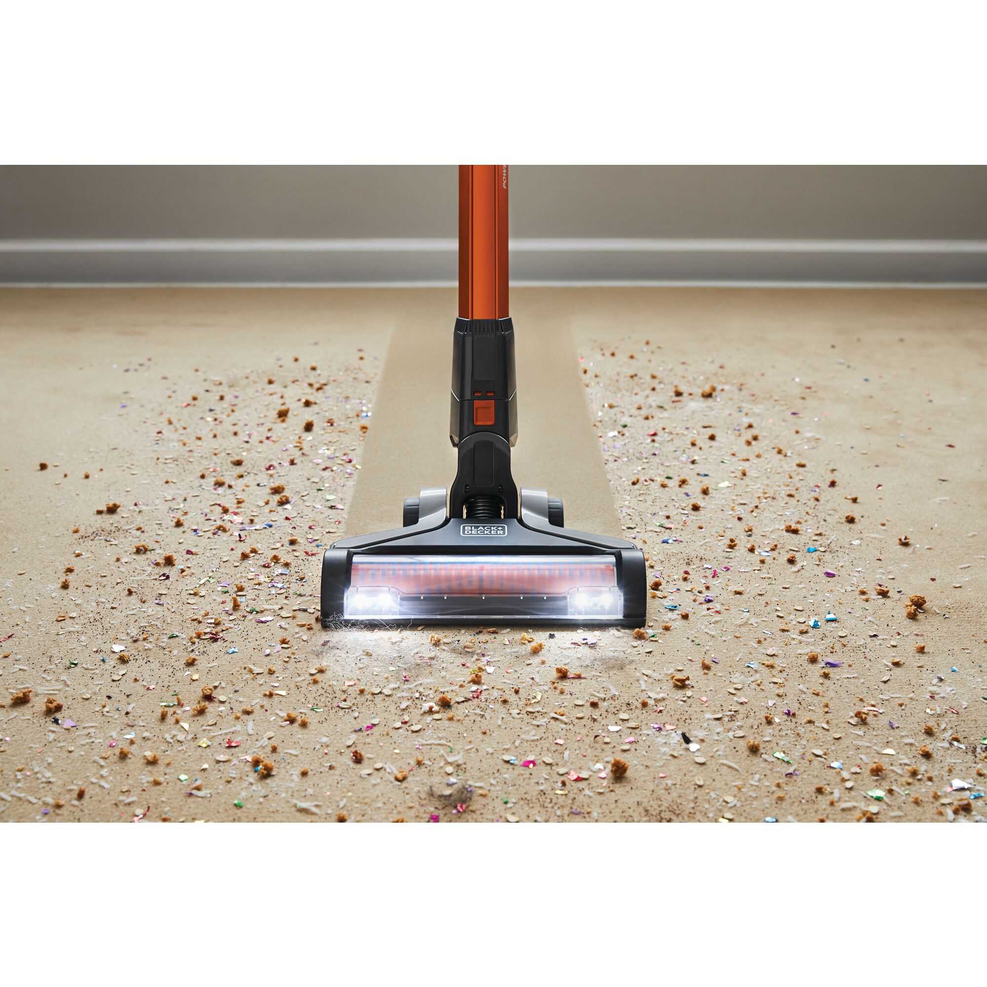POWERSERIES Extreme Cordless Stick Vacuum Cleaner being used to clean food mess from carpet.