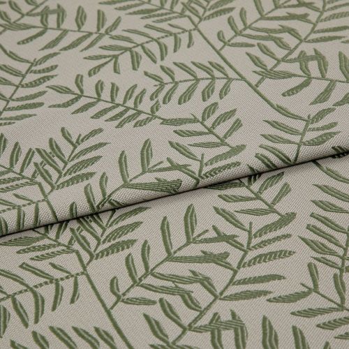 Beige woven fabric panel printed with green fern-like branches (textured weave) â€” lying with two overlapping folds â€” close-up on a neutral surface under soft, even lighting.