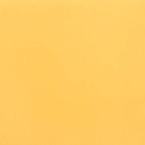 Solid pale orange sheet filling the frame, lying flat and motionless; evenly lit with subtle texture, minimal studio backdrop.