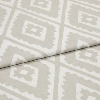 Folded woven upholstery fabric with beige-and-white diamond Aztec-style pattern, folded diagonally across the frame; crisp texture visible, photographed in soft, even studio lighting as a close-up.