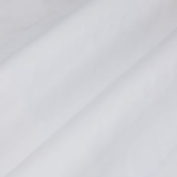 White fabric with a prominent diagonal fold, draped smoothly across the frame showing soft creases; close-up view under diffuse, neutral lighting with no visible surroundings.