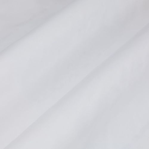 White fabric with a prominent diagonal fold, draped smoothly across the frame showing soft creases; close-up view under diffuse, neutral lighting with no visible surroundings.