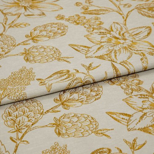 Cream fabric with mustard-gold botanical print, folded and overlapped to reveal panels; studio-lit close-up showing woven texture and repeating floral pattern.