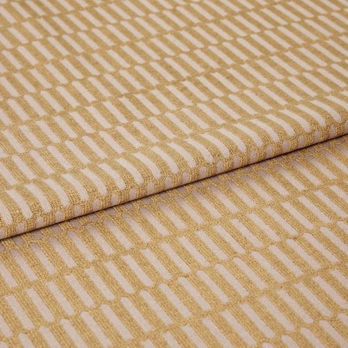 Woven upholstery fabric with a raised golden rectangular grid, folded over itself; pattern repeats diagonally across the surface, shown in a close-up, studio-lit view on a neutral background.