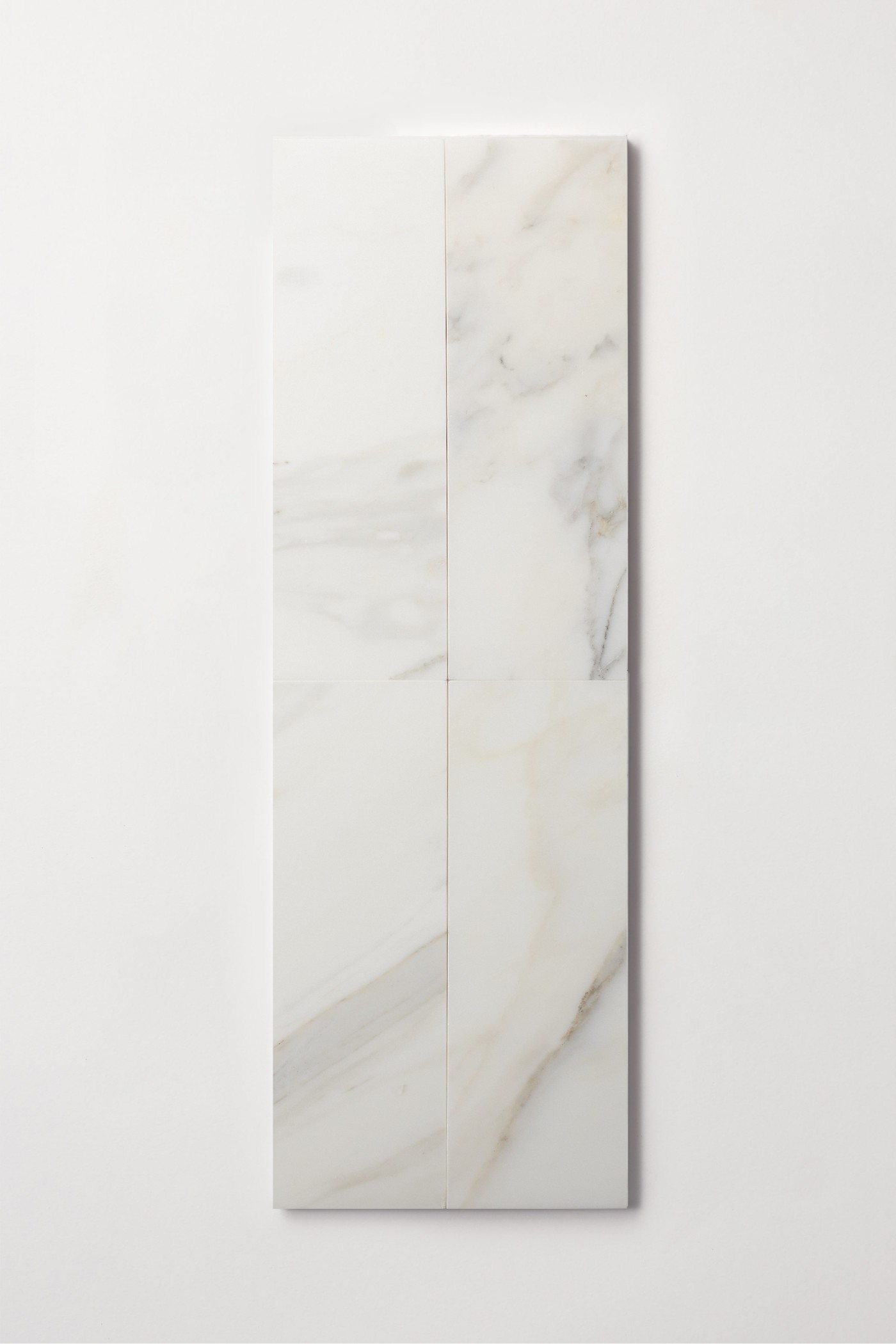 a white rectangular marble tile on a white surface.
