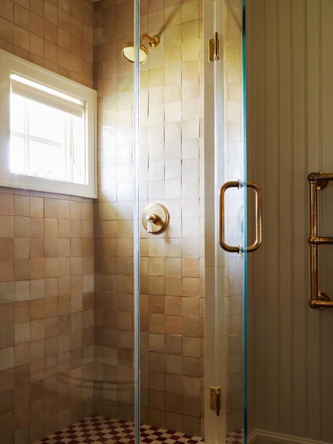 a tiled shower with a glass door.