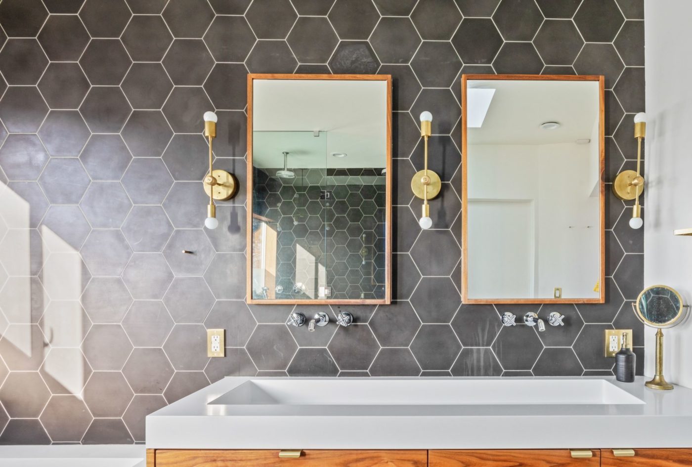 a bathroom with two sinks and two mirrors.