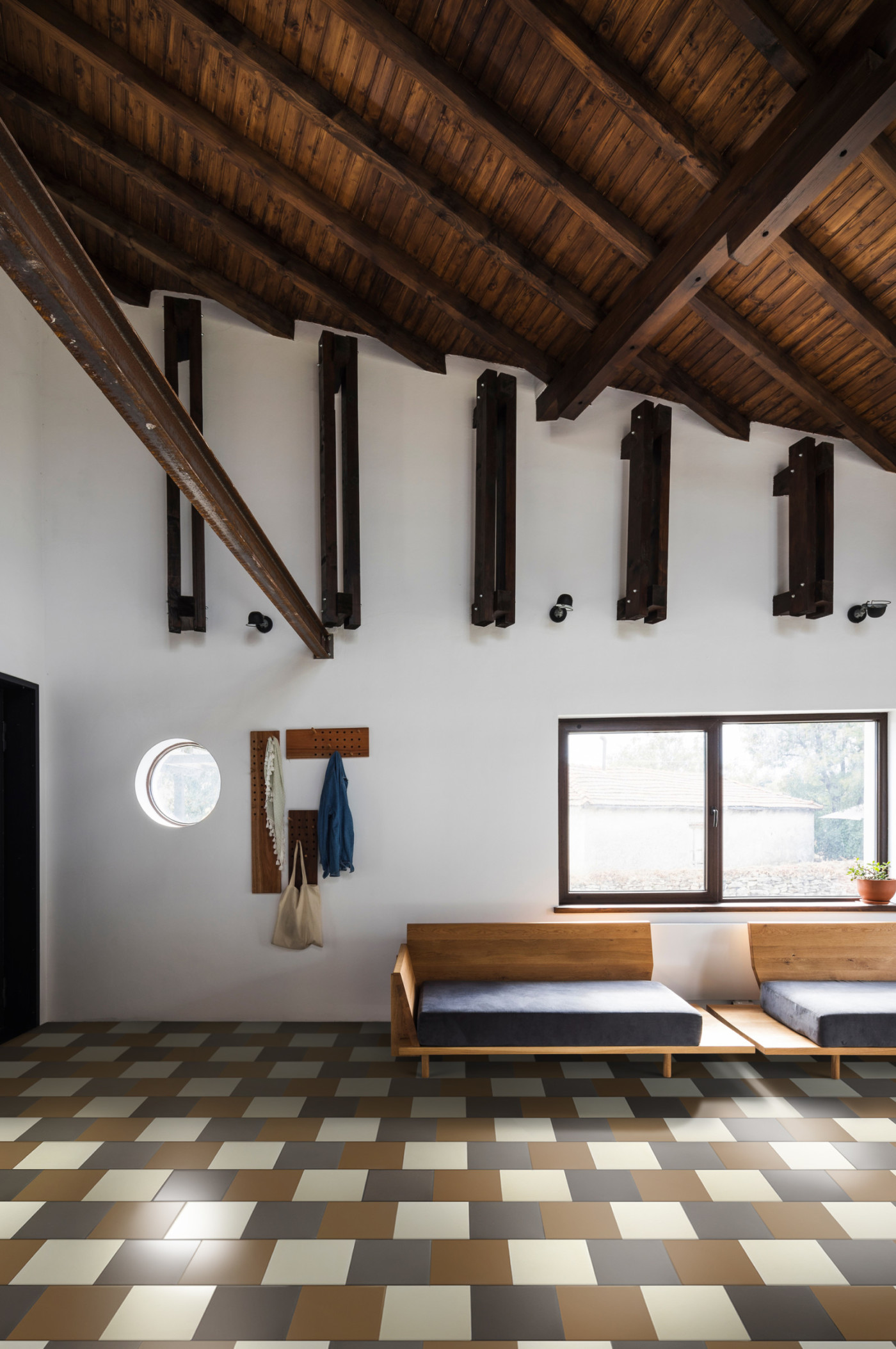 a room with wooden beams and chckered tile floors.