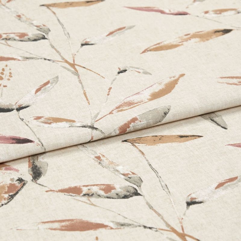 Beige linen-like fabric with muted watercolor leaf pattern, folded over itself creating a horizontal crease; displayed as a studio close-up with soft, even lighting.