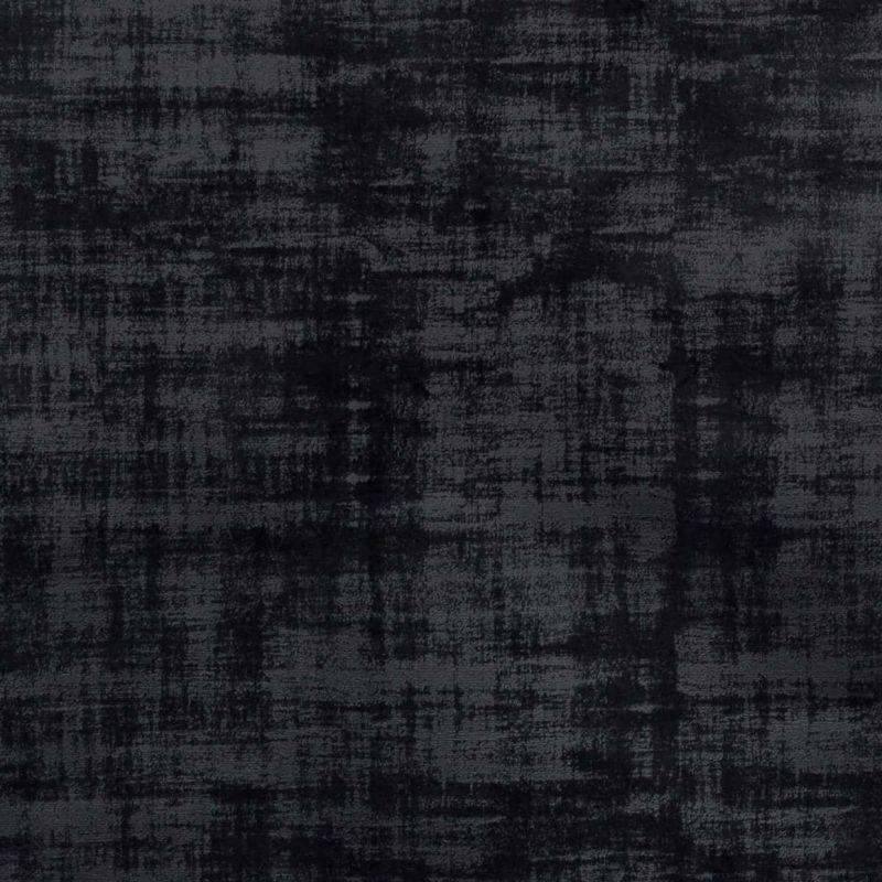 Dark charcoal fabric with a distressed, crosshatched texture (velvet-like), lying flat; displaying uneven shading and a worn appearance in diffuse, low-contrast lighting, like an upholstery or rug sample.