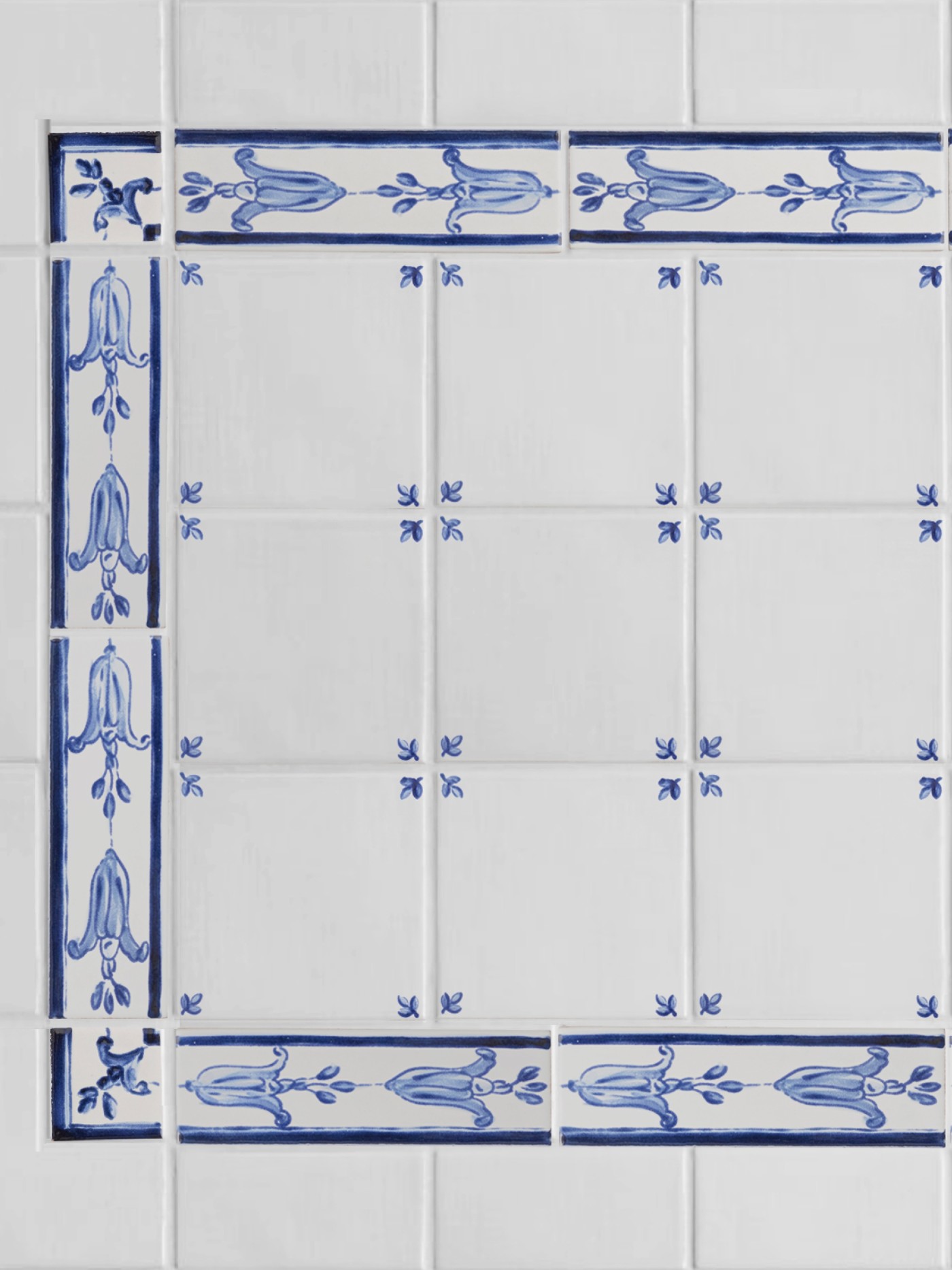 a blue and white tiled wall with a decorative border.