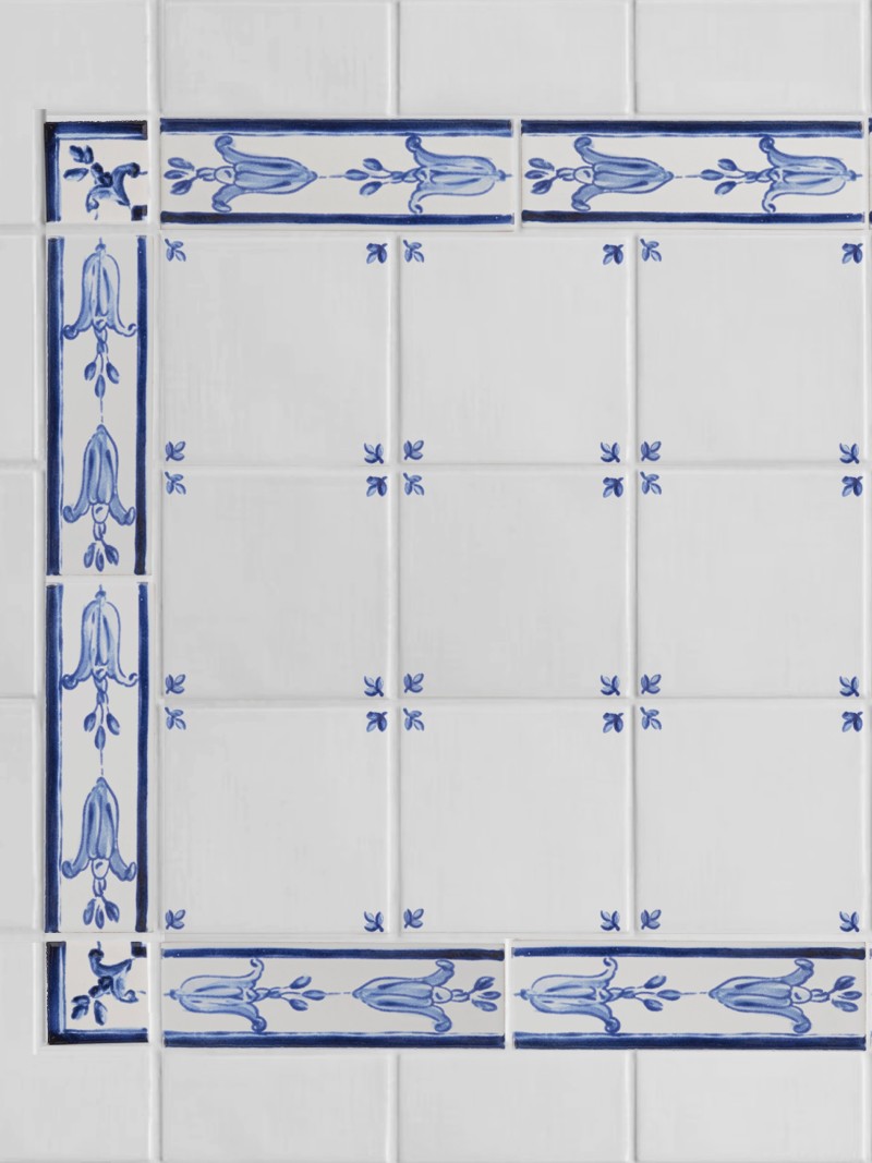 a blue and white tiled wall with a decorative border.