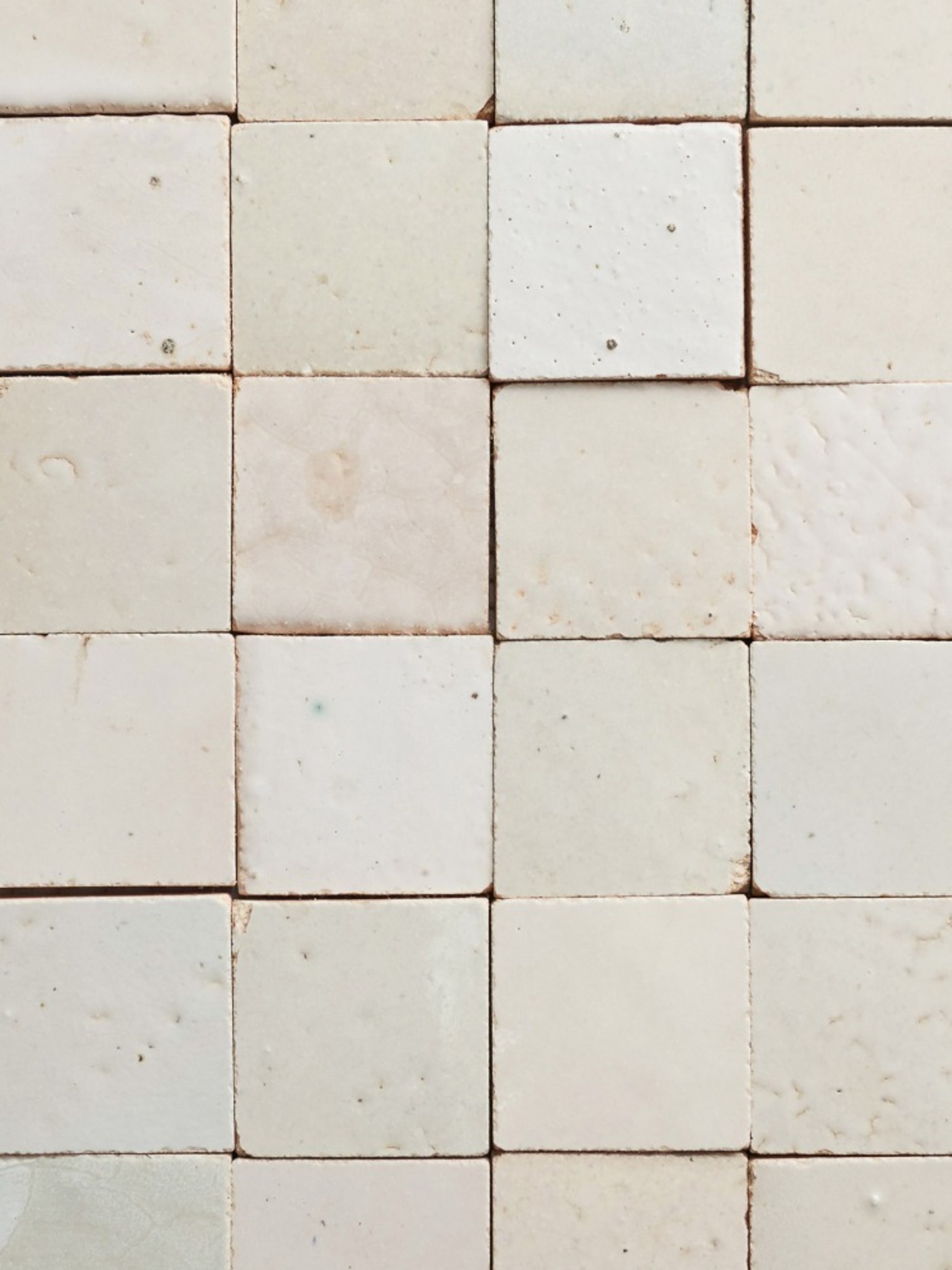 a close up image of a white tile wall.