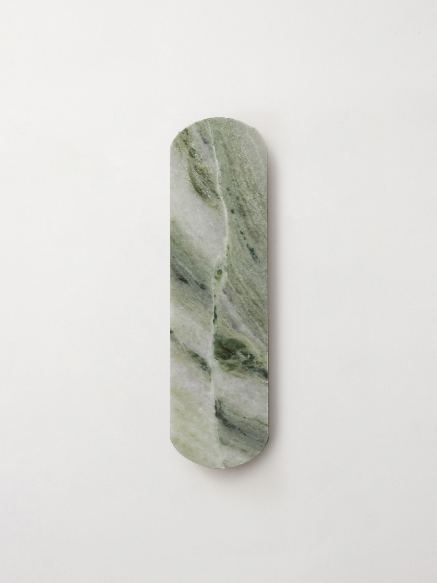 an oval piece of green marble tile on a white surface.