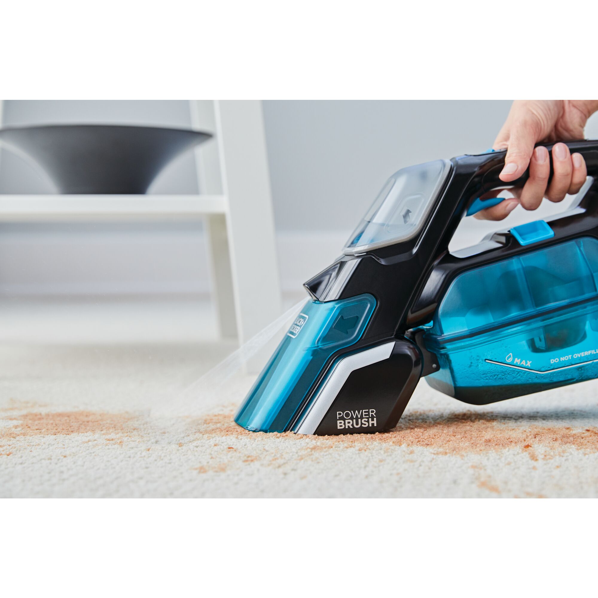 Spillbuster Cordless Spill plus Spot Cleaner with Powered Scrub Brush being used to scrub stains from carpet.