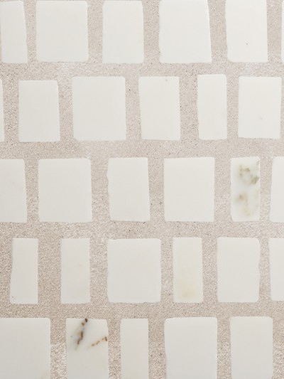 white marble tiles on a beige surface.