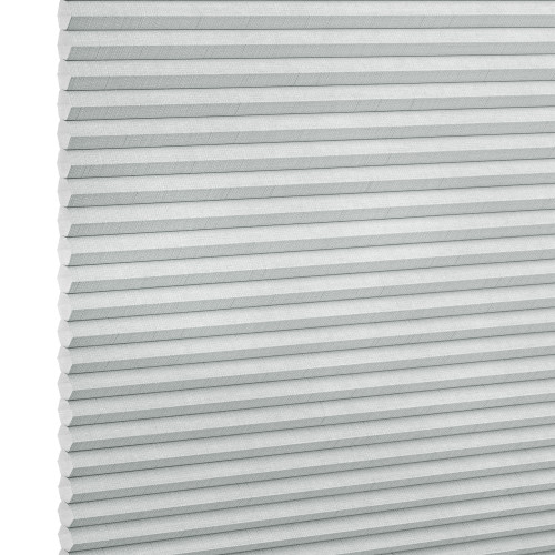 Light-gray pleated cellular blind with horizontal honeycomb folds, fully lowered and closed, filtering diffuse light in a neutral, softly lit interior; close-up view.