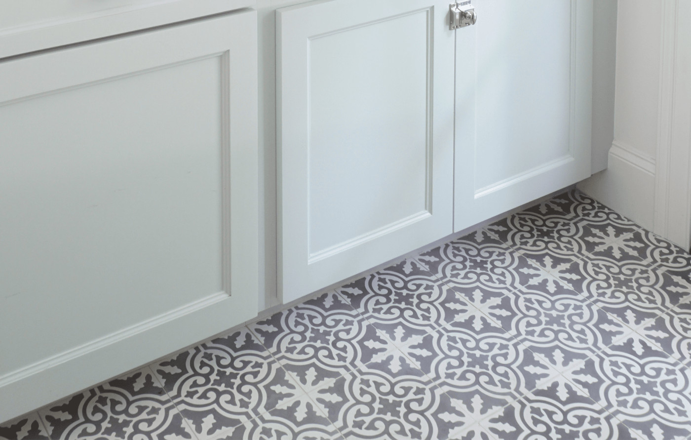 a bathroom with a grey and white tile floor.