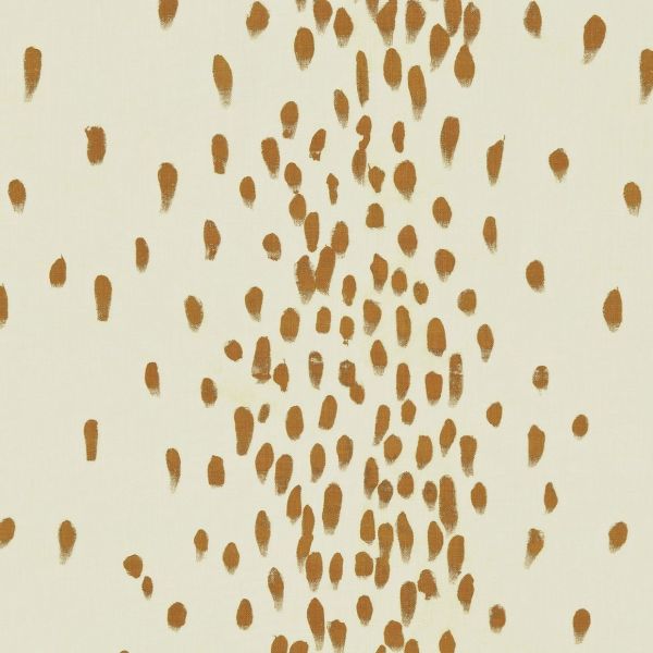 Ochre brushstroke dabs across a cream surface; hand-painted dots clustered densely in a vertical band and sparser toward edges; presented as a minimalist wallpaper or textile pattern in neutral lighting.