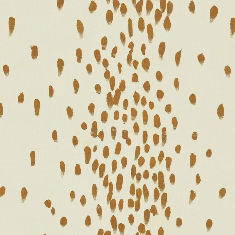 Ochre brushstroke dabs across a cream surface; hand-painted dots clustered densely in a vertical band and sparser toward edges; presented as a minimalist wallpaper or textile pattern in neutral lighting.