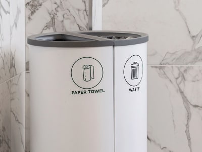 powder coated steel waste and recycling bins in a hotel washroom