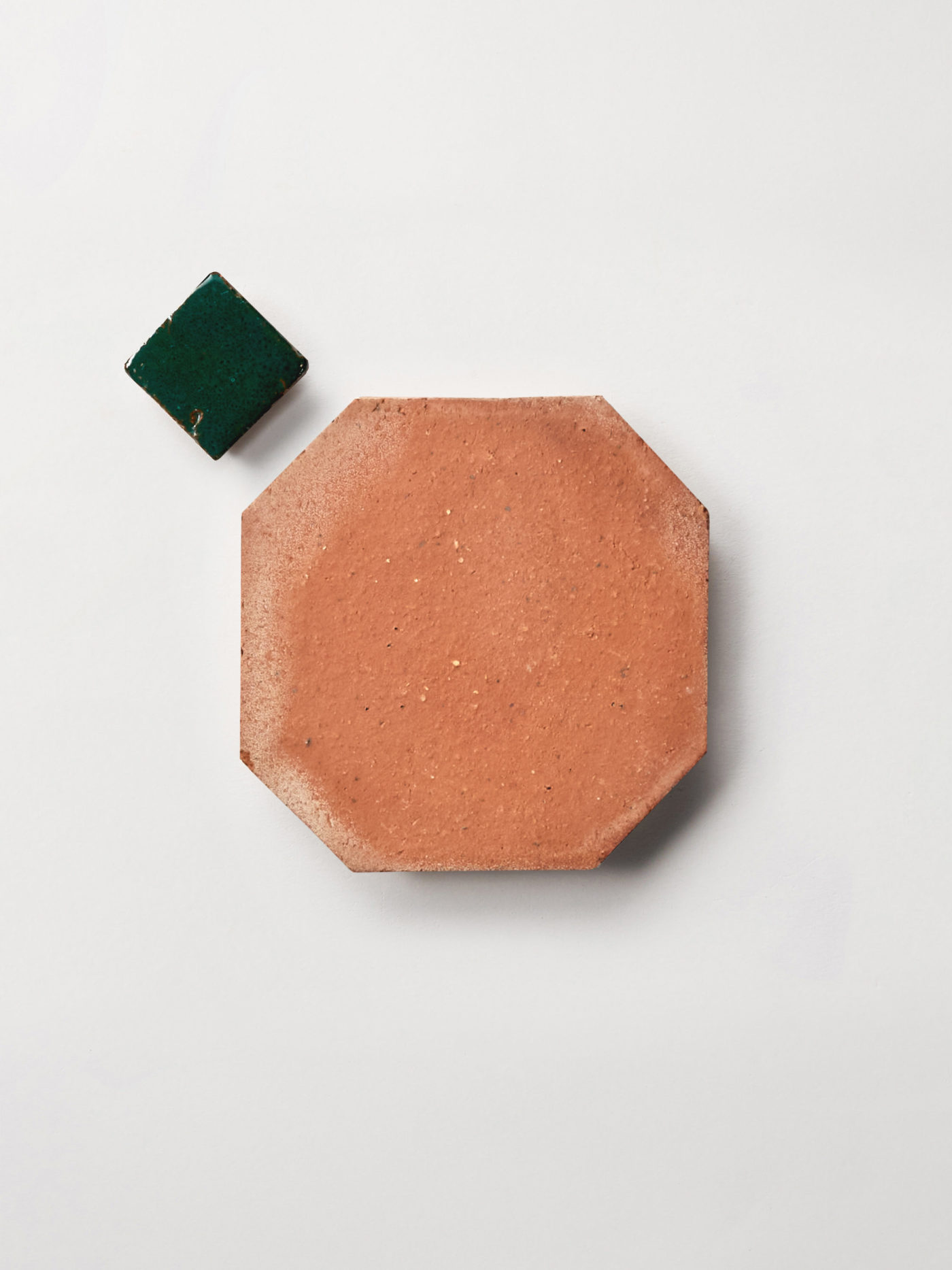 green and terracotta tiles on a white surface.