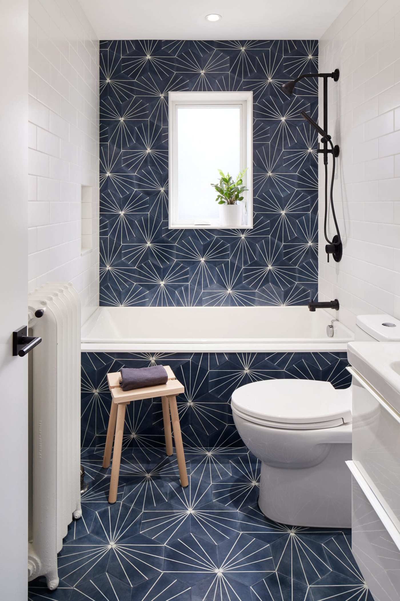 a bathroom with a blue and white tiled floor.