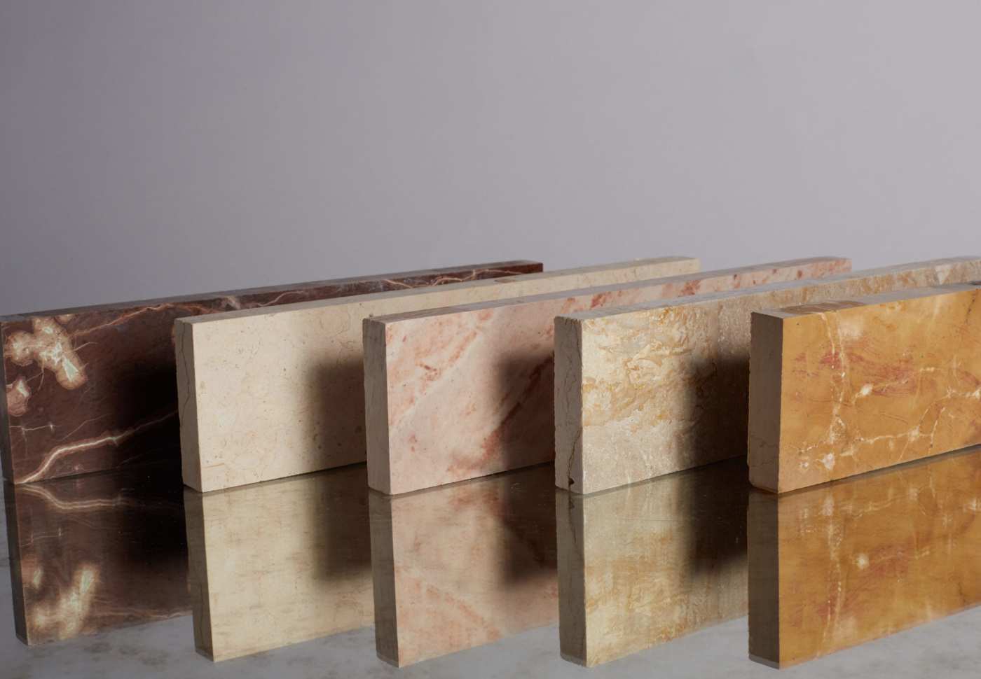 a row of marble tiles on a reflective surface.